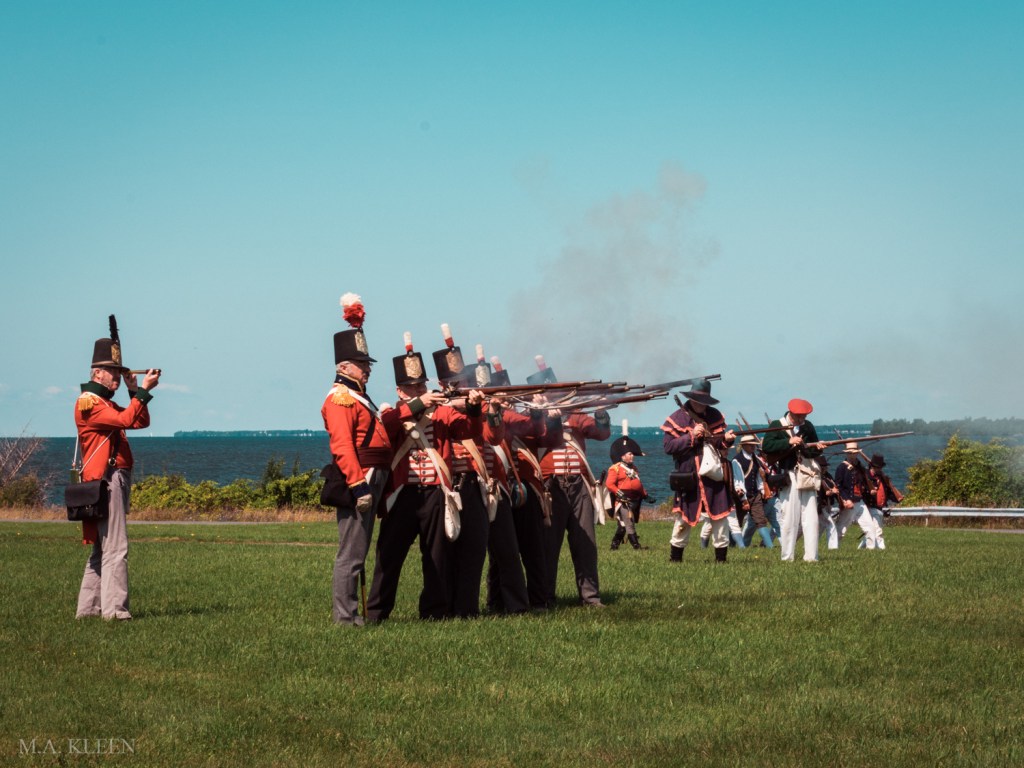 Reenactors dressed as British soldiers fire a volley during an event commemorating the Second Battle of Sacket’s Harbor, fought on May 29, 1813.